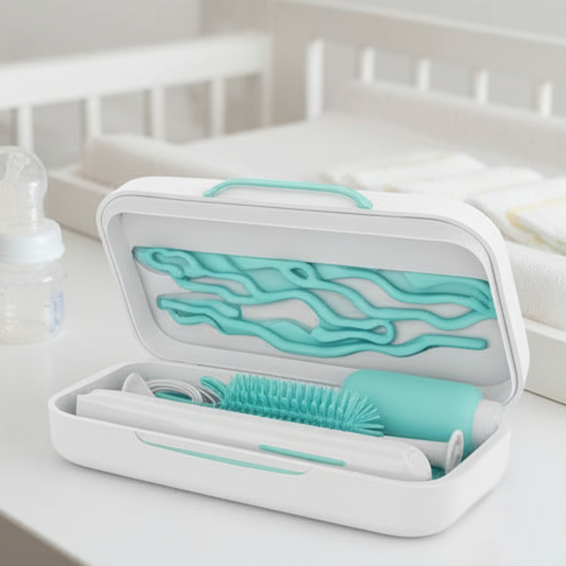 Teal and white baby bottle cleaning brush set in a carrying case on a white surface.