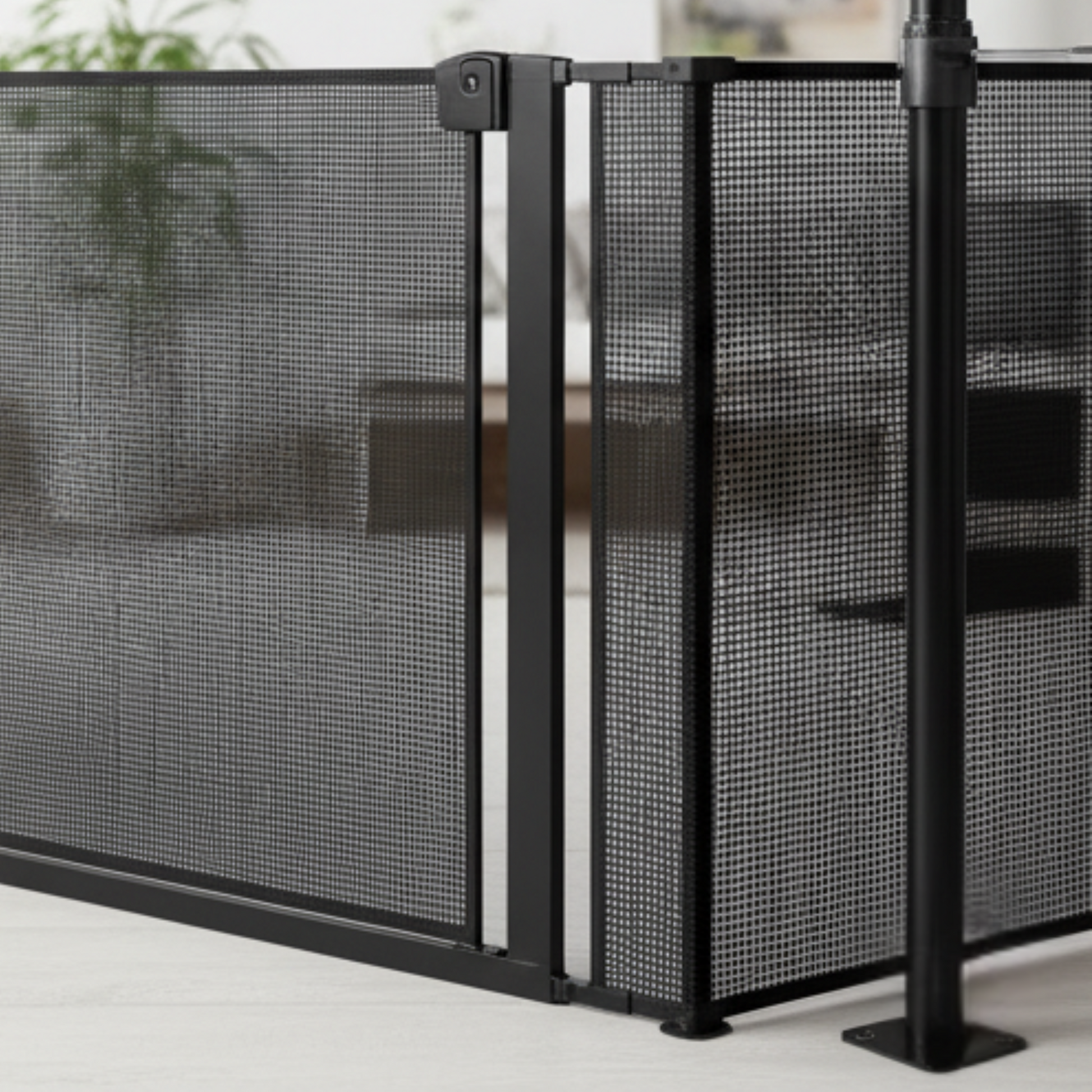 Black mesh screen enclosure on a white surface with a blurred background