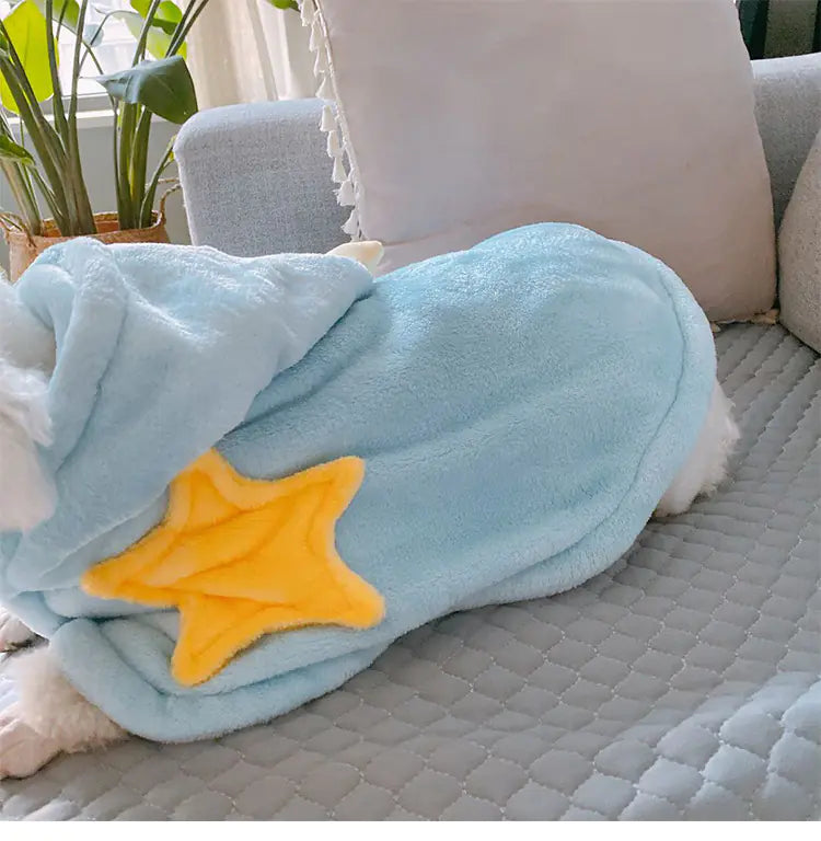 Light blue blanket with a yellow star on a gray couch